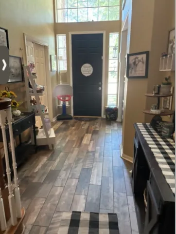a view of a livingroom with furniture and a window