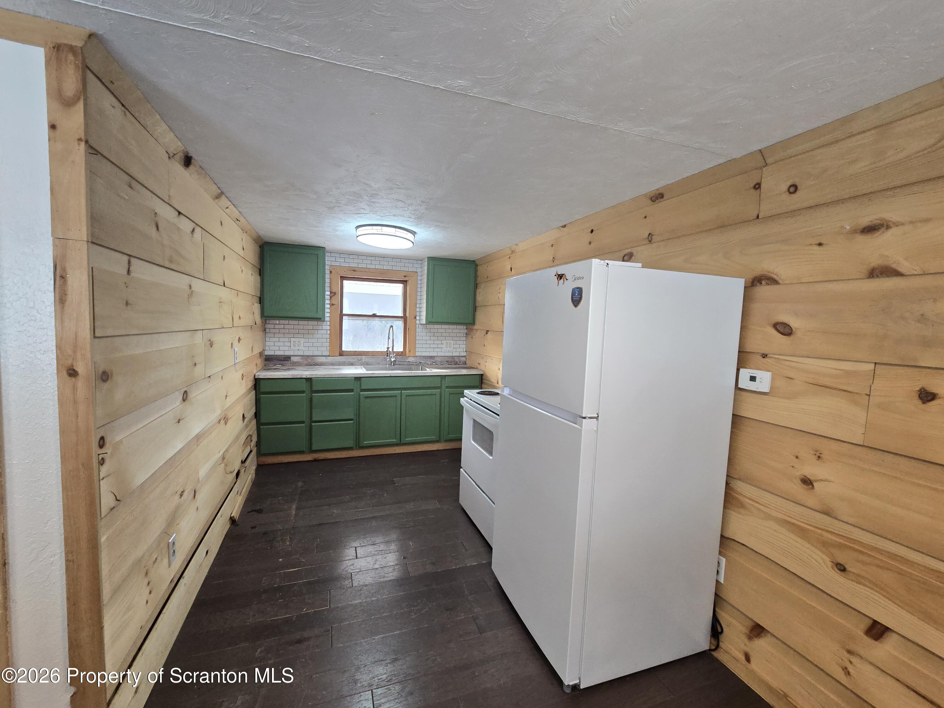 483 Turnpike Street Susquehanna, PA 18847 - Photo 18 of 27 a kitchen with a refrigerator and a stove