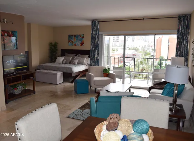 a living room with furniture and a floor to ceiling window