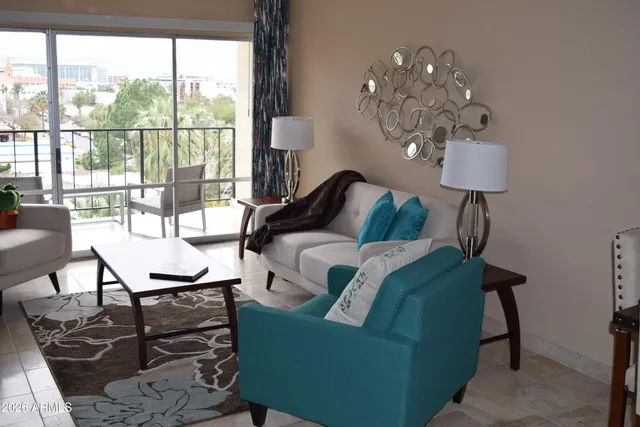 a living room with furniture a lamp and a window