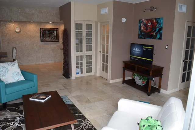 a living room with furniture and a flat screen tv
