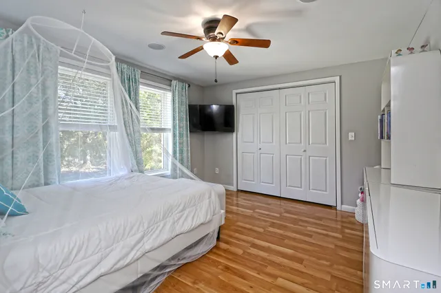 a bedroom with a bed and a chandelier