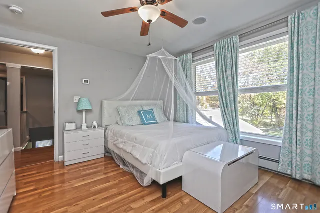 a spacious bedroom with a bed and a chandelier