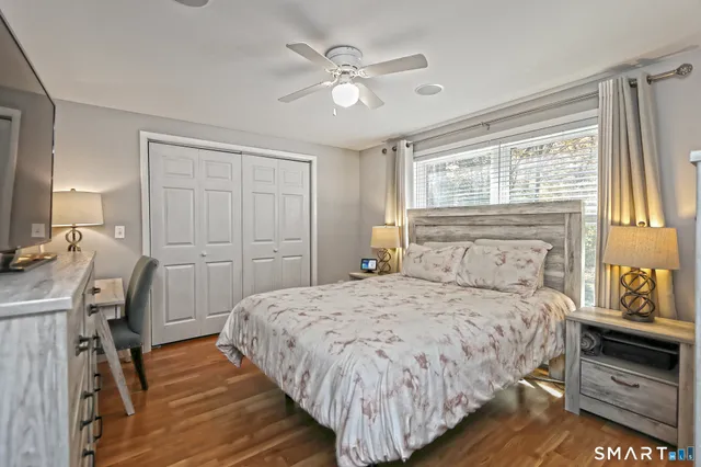 a bedroom with a bed and a table in it