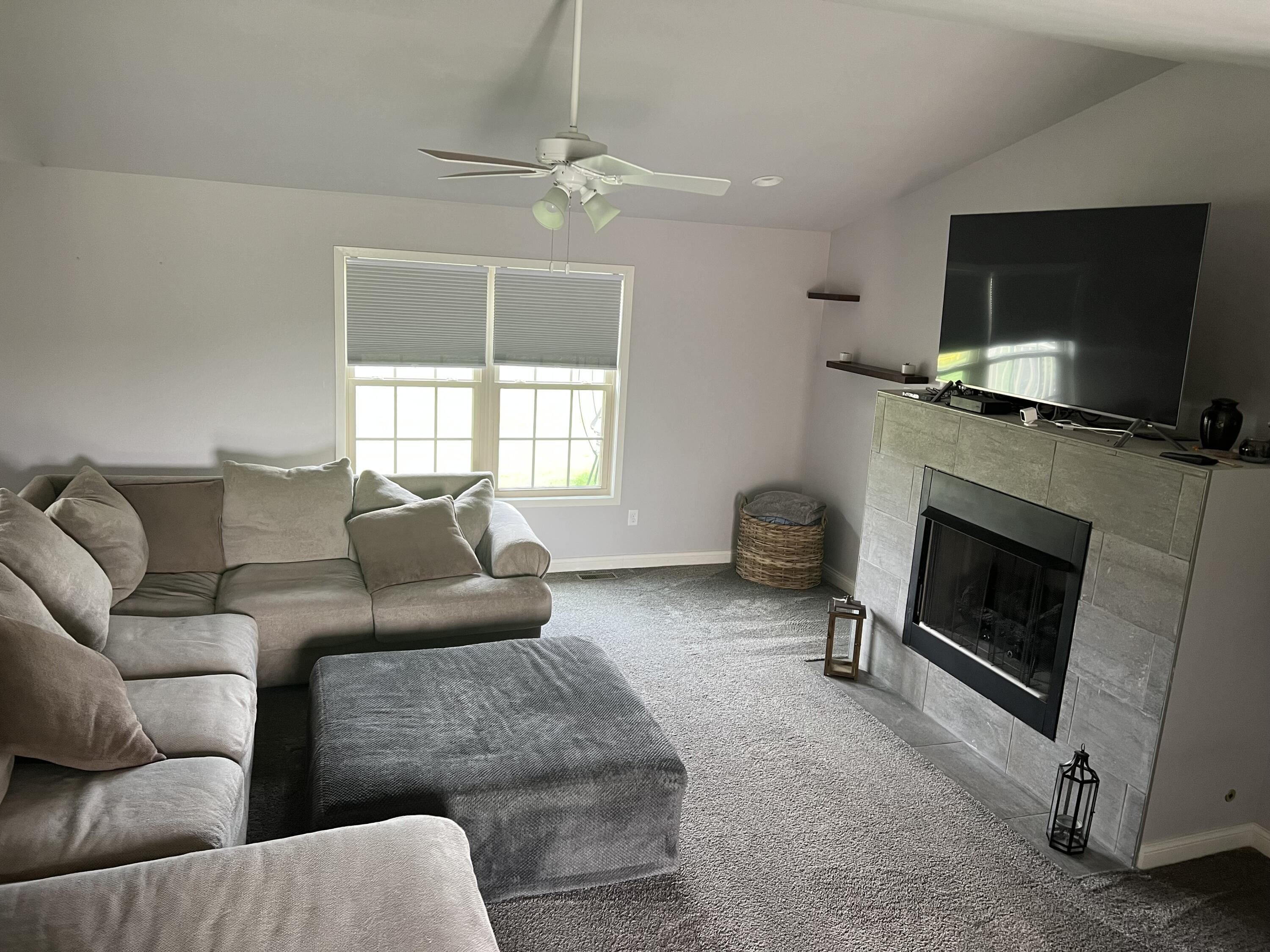 702 19th Street Southeast De Motte, IN 46310 - Photo 5 of 22 a living room with furniture a flat screen tv and a fireplace