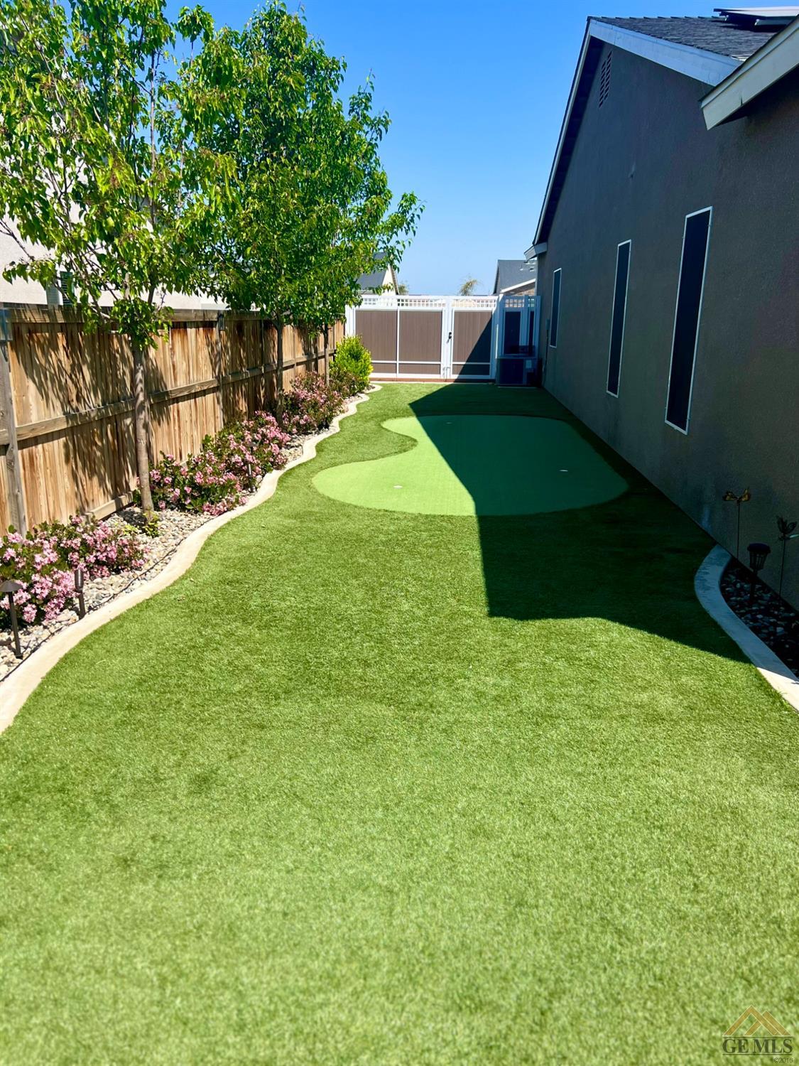 Undisclosed Address Shafter, CA 93263 - Photo 8 of 11 a backyard of a house with lots of green space