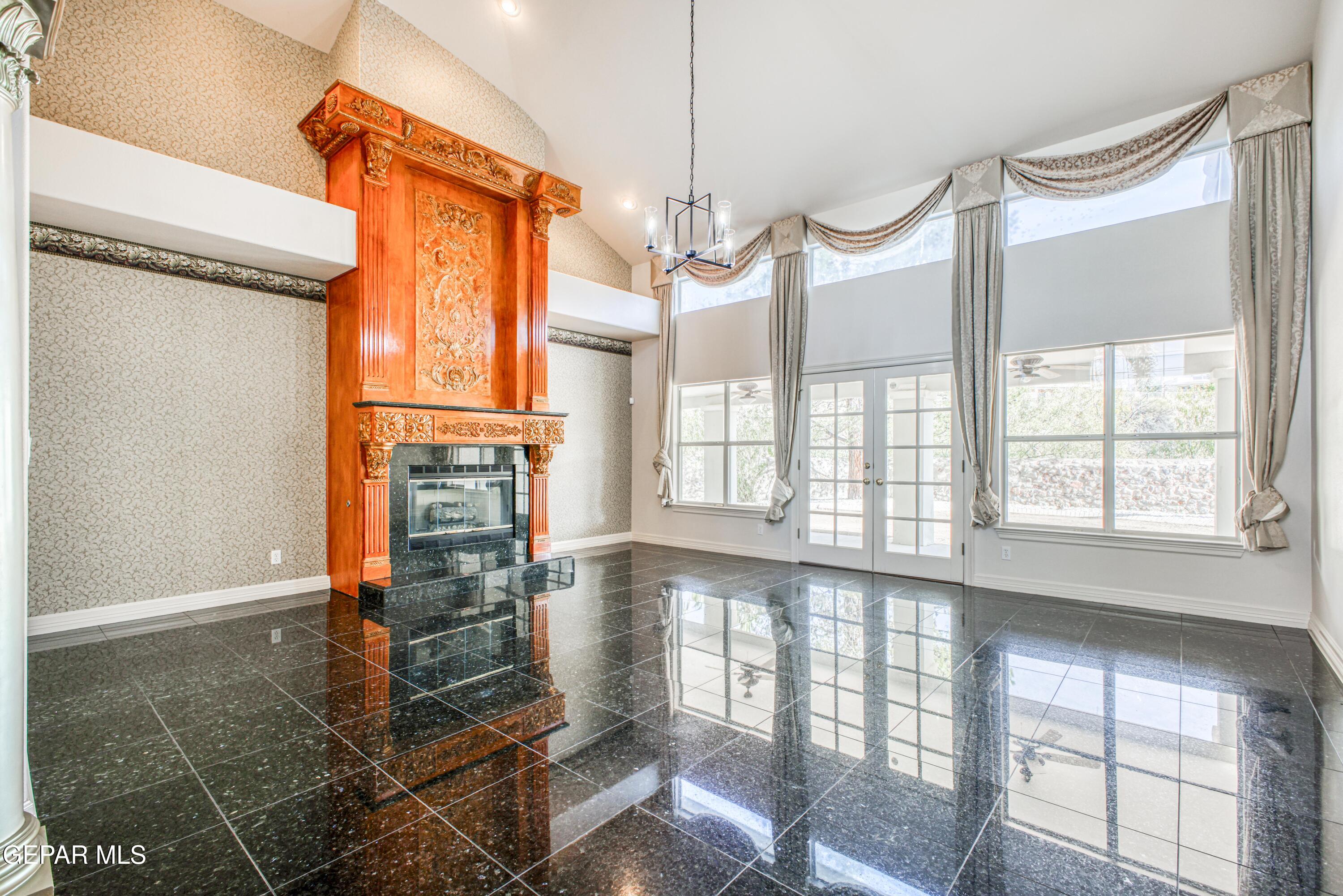 6565 Eagle Ridge Drive El Paso, TX 79912 - Photo 11 of 60 a view of a living room with a floor to ceiling window and wooden floor