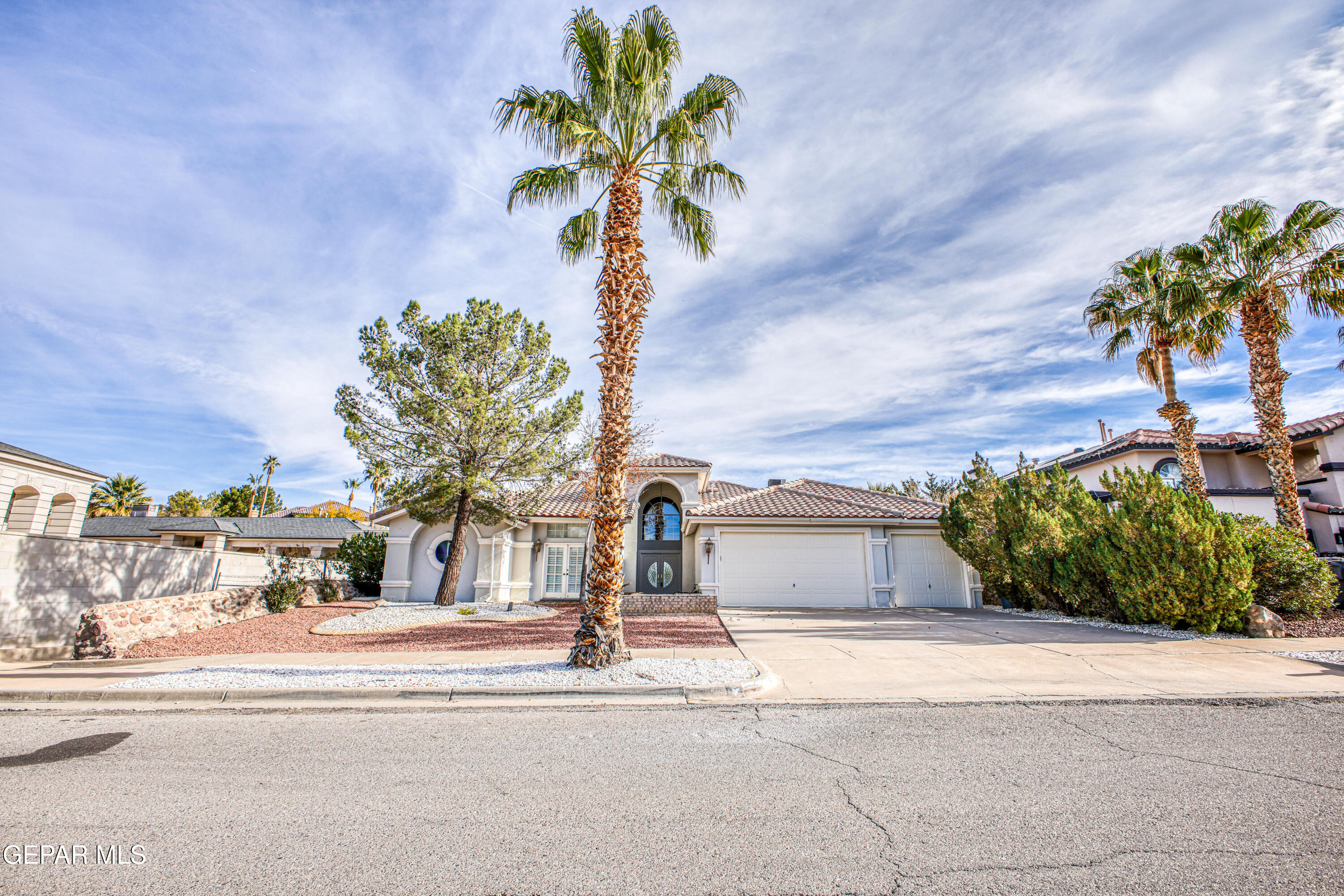 6565 Eagle Ridge Drive El Paso, TX 79912 - Photo 2 of 60 a front view of a house with a yard and garage