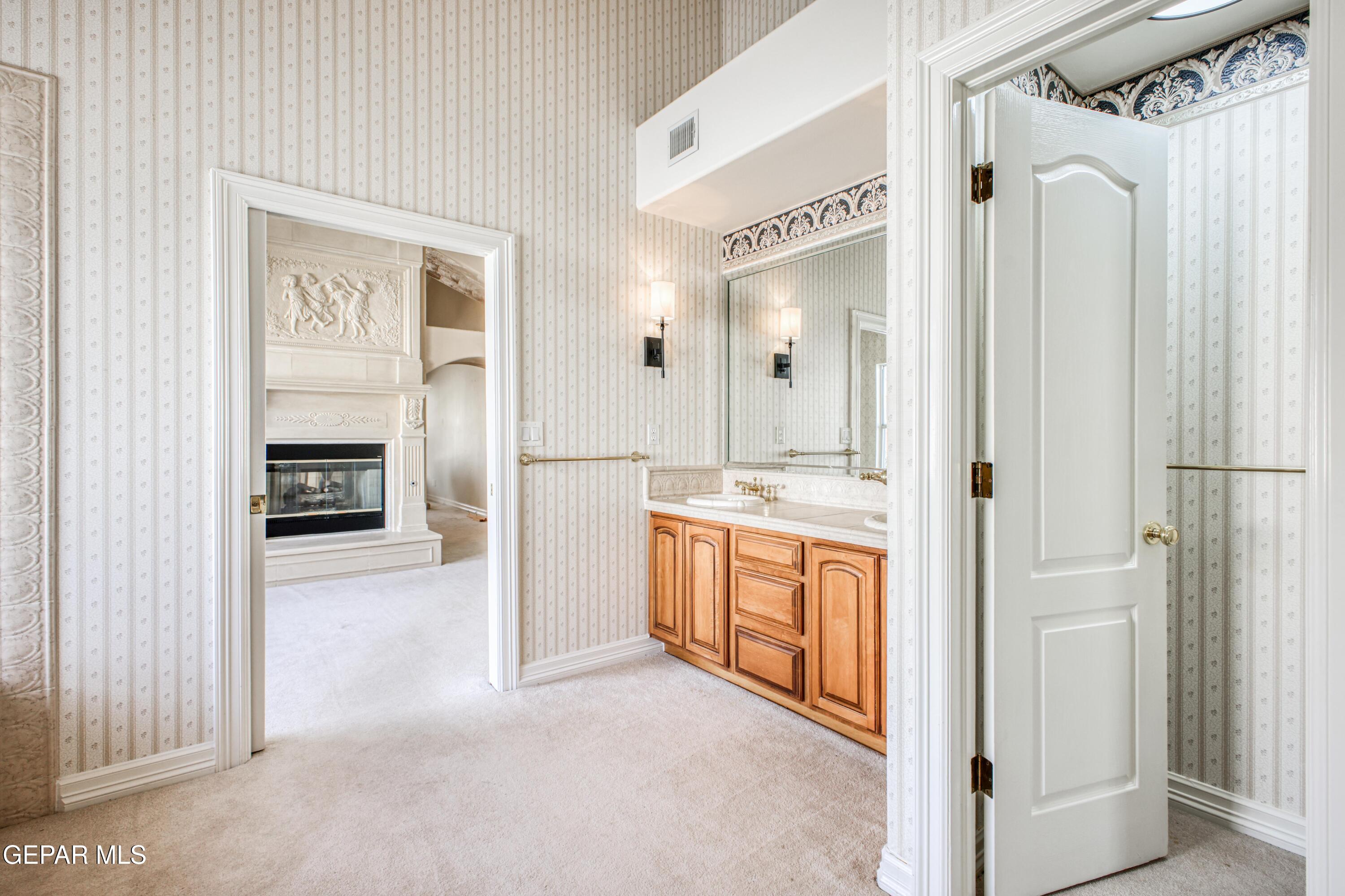 6565 Eagle Ridge Drive El Paso, TX 79912 - Photo 29 of 60 a view of a hallway with a bathroom and a sink