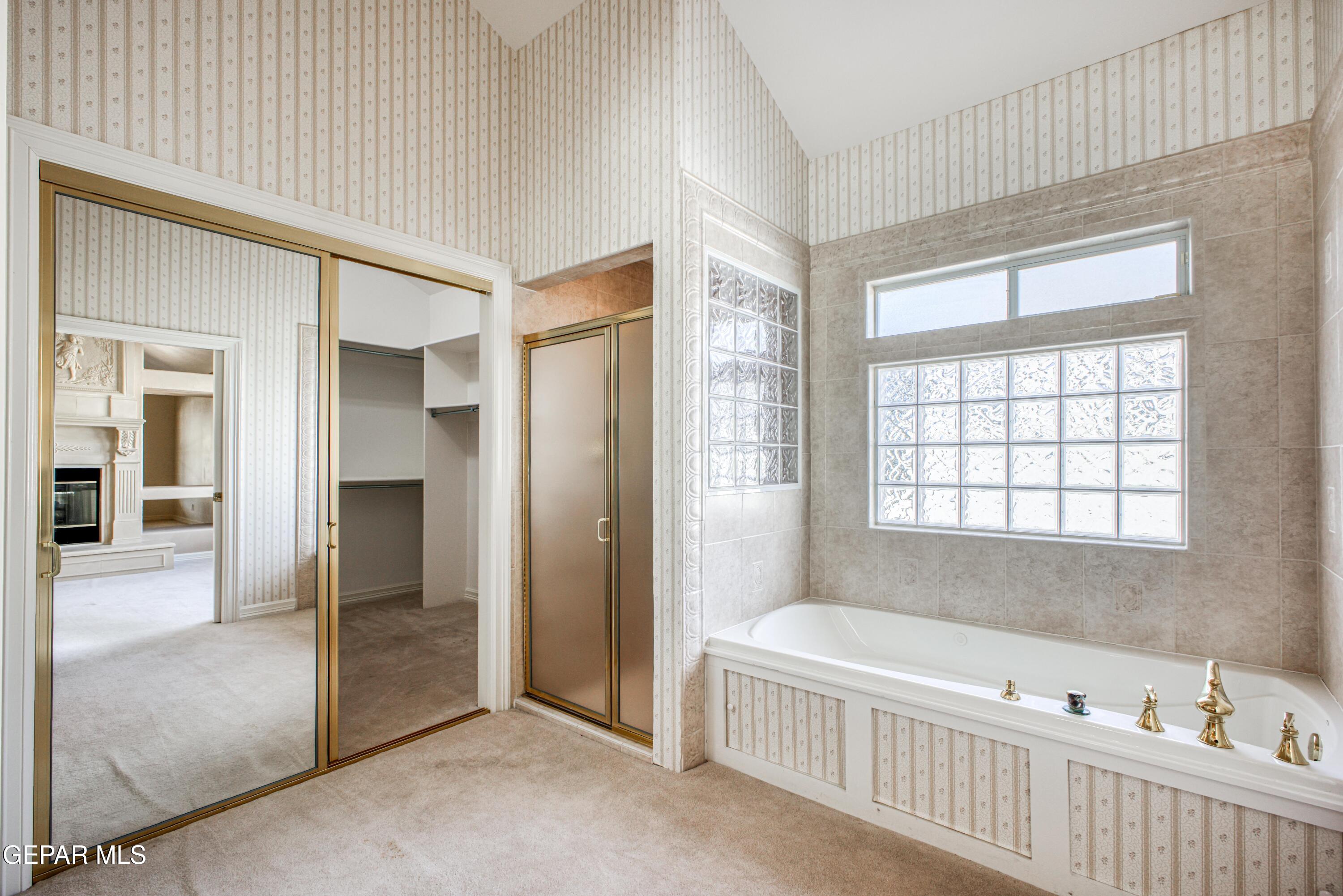 6565 Eagle Ridge Drive El Paso, TX 79912 - Photo 30 of 60 a bathroom with a bathtub and a shower