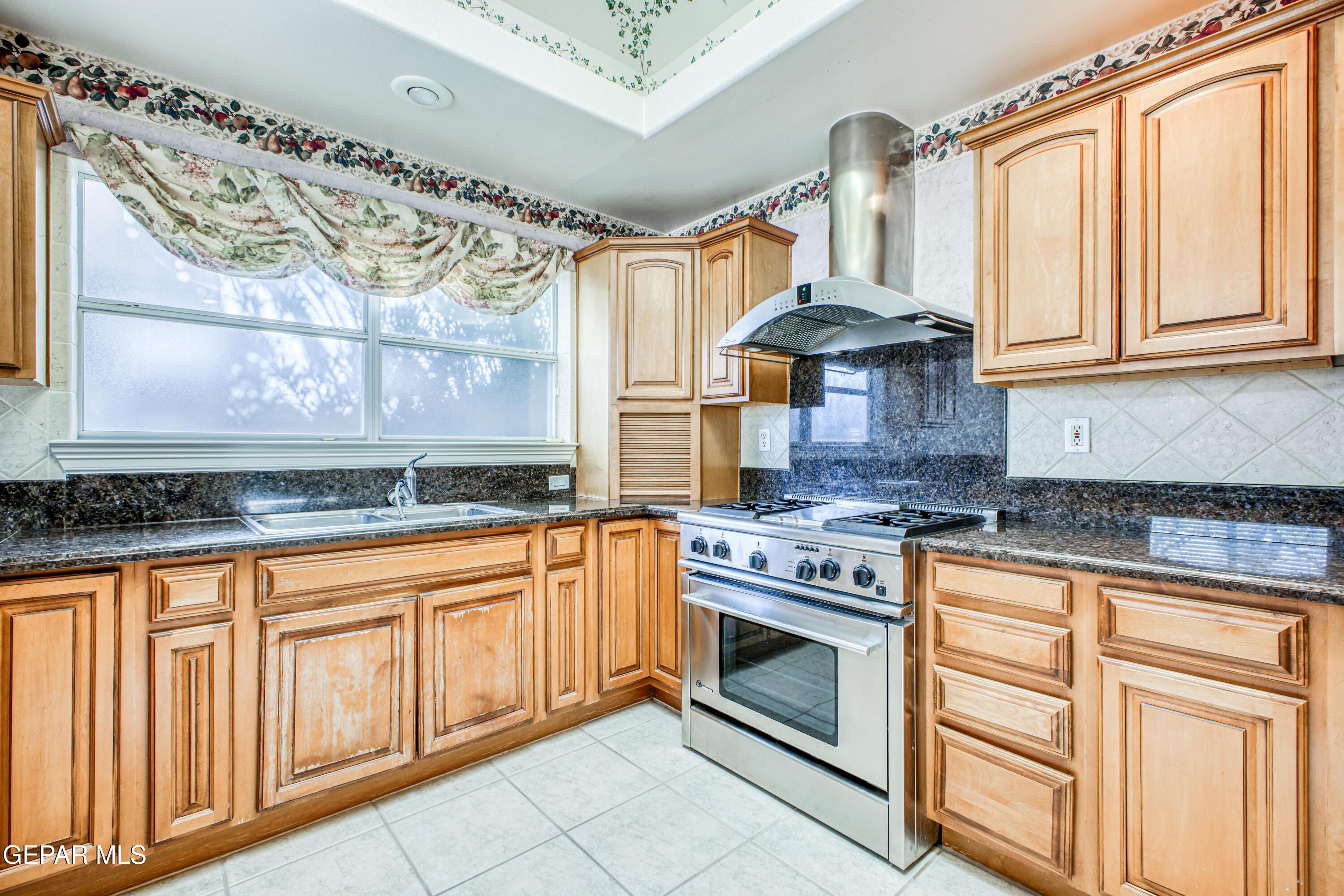 6565 Eagle Ridge Drive El Paso, TX 79912 - Photo 45 of 60 a kitchen with stainless steel appliances granite countertop a stove and a sink