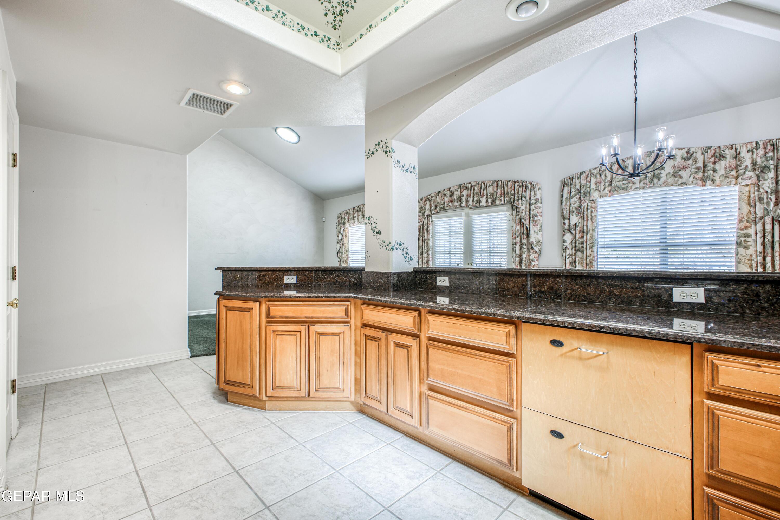 6565 Eagle Ridge Drive El Paso, TX 79912 - Photo 47 of 60 a large bathroom with a sink and a mirror