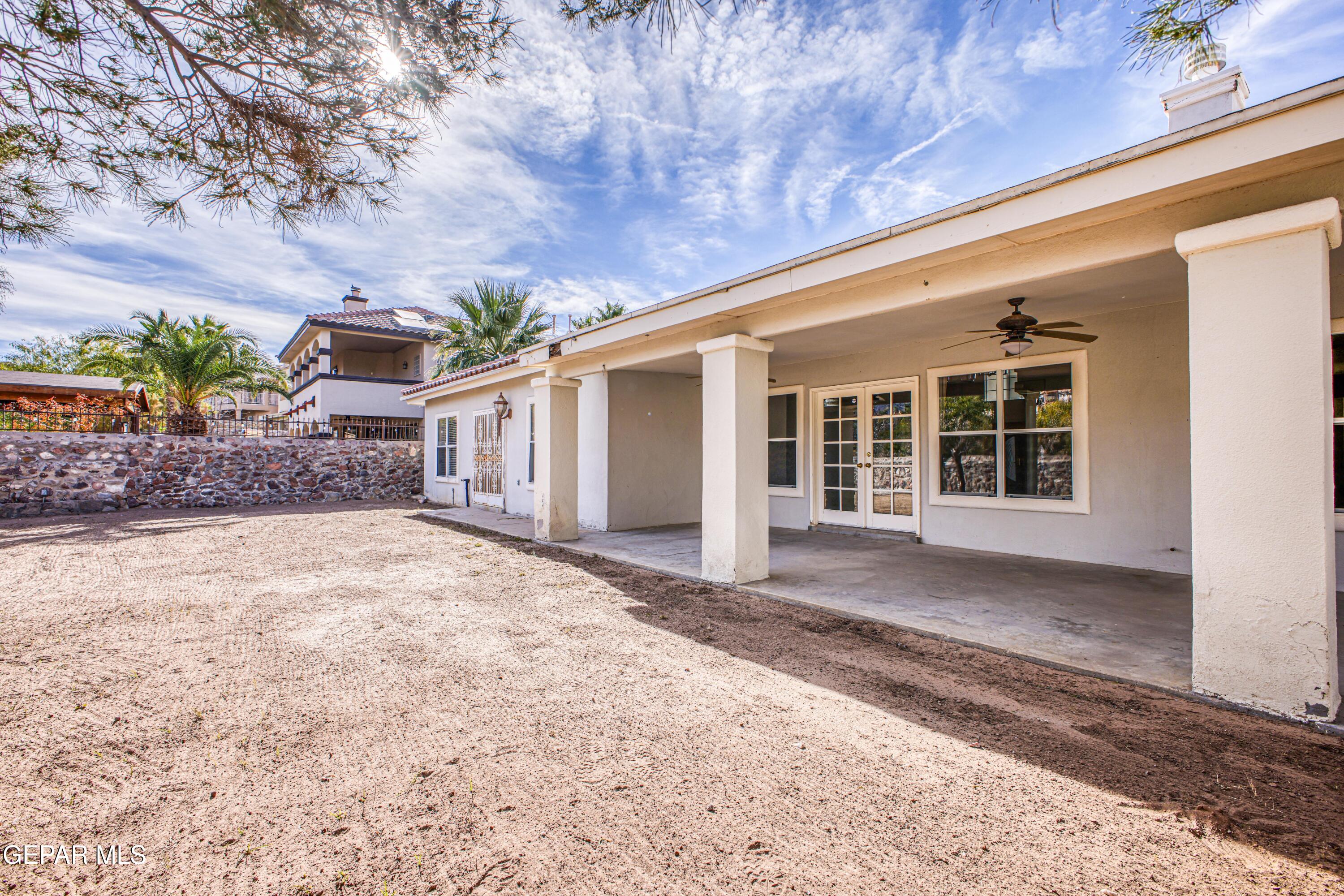 6565 Eagle Ridge Drive El Paso, TX 79912 - Photo 54 of 60 a front view of a house with a yard and garage