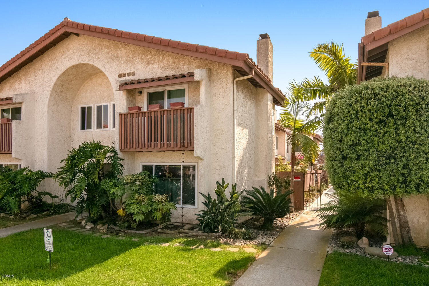 5120 West Wooley Road, Unit 2 Oxnard, CA 93035 - Photo 3 of 35 a front view of a house with a yard