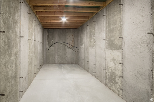 3322 250 S Street Vernal, UT 84078 - Photo 30 of 37 Unfinished basement space featuring concrete walls, a concrete floor, and an exposed wood joist ceiling