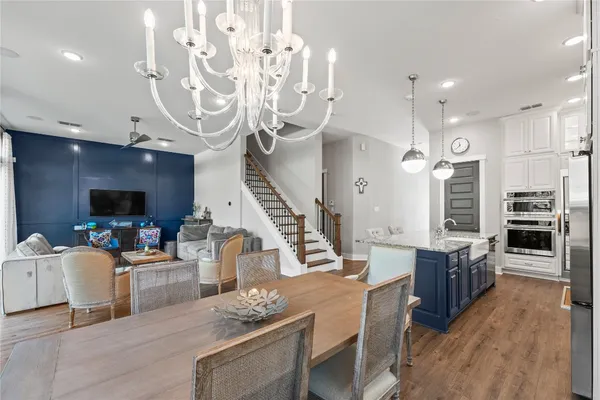 a living room with furniture a flat screen tv and kitchen view