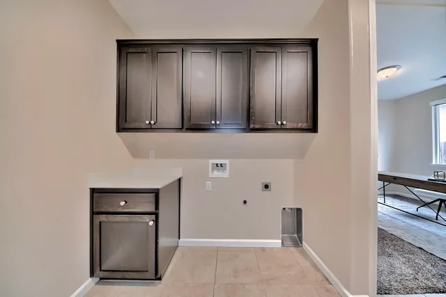a living room with furniture potted plant and a large window