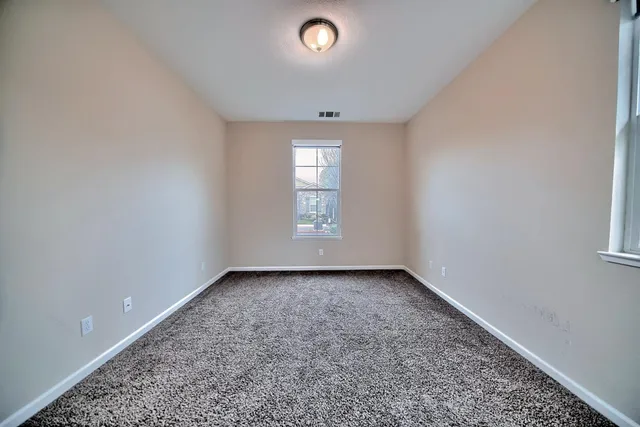 a living room with fireplace furniture and a large window