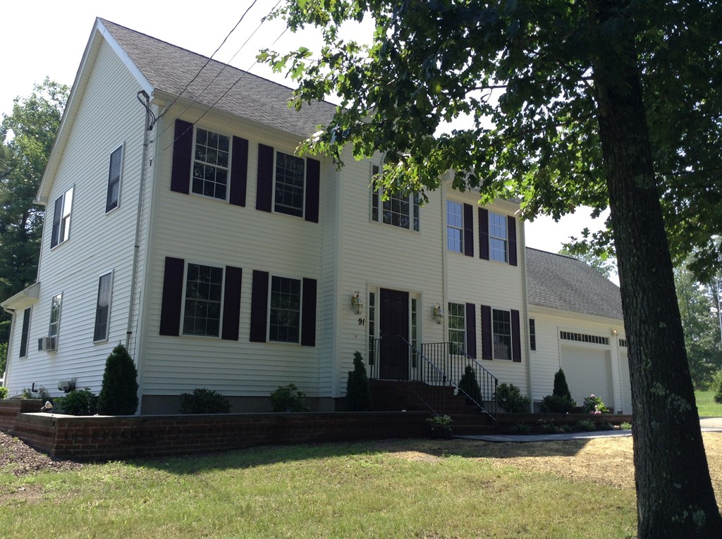 91 Haggerty Road Charlton, MA 01507 - Photo 1 of 15 a view of a white house with a large tree