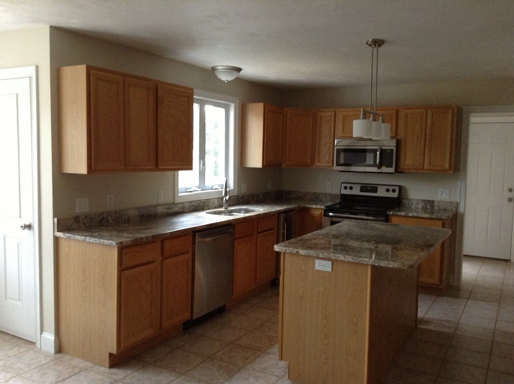 91 Haggerty Road Charlton, MA 01507 - Photo 4 of 15 a kitchen with stainless steel appliances granite countertop a sink stove and microwave
