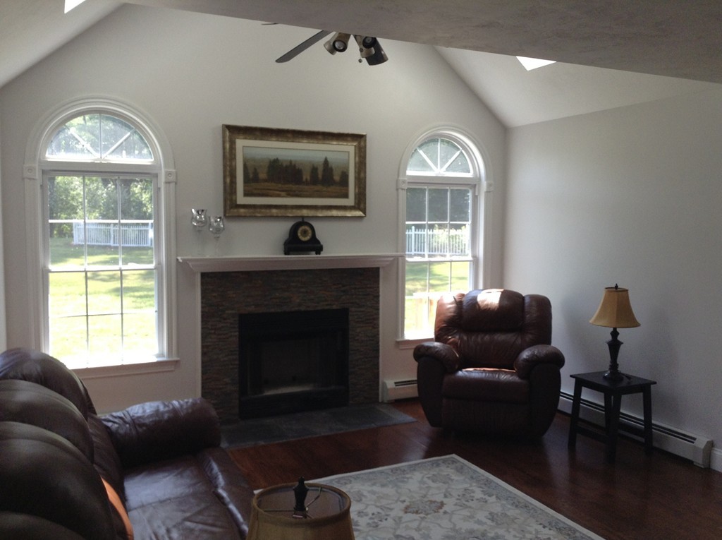 91 Haggerty Road Charlton, MA 01507 - Photo 6 of 15 a living room with furniture a window and a fireplace