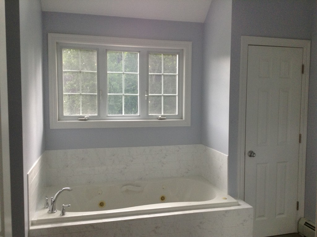 91 Haggerty Road Charlton, MA 01507 - Photo 10 of 15 a bathroom with bathtub and window