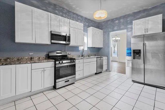 a kitchen with a stove a sink and a refrigerator