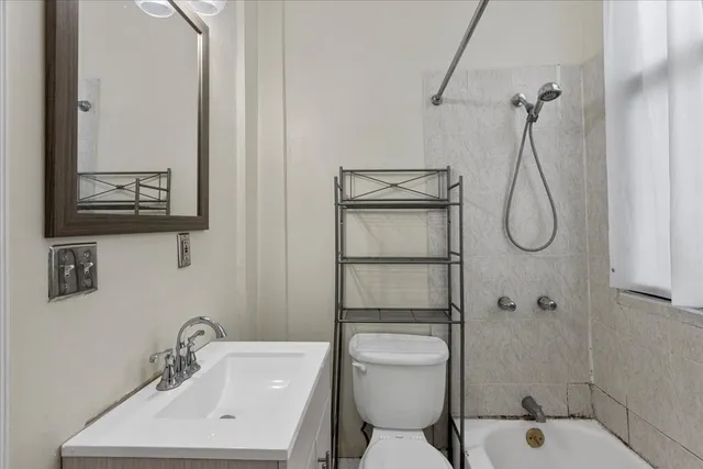 a bathroom with a toilet sink shower and mirror