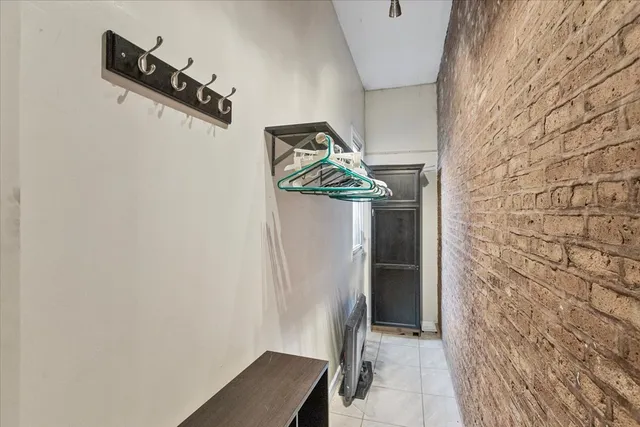 a view of an empty room with cabinet and entryway