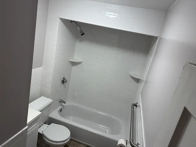 a bathroom with a toilet and a bathtub