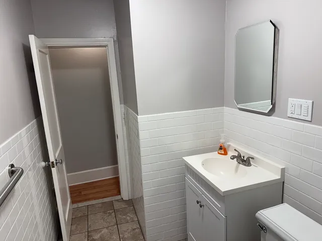 a bathroom with a sink a toilet and a mirror