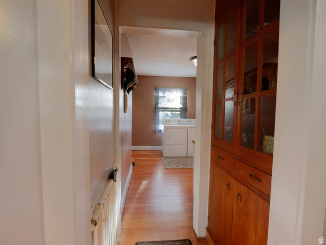 155 West Center Street Fillmore, UT 84631 - Photo 31 of 86 Hallway featuring wood-finish flooring, built-in cabinetry with glass-paneled doors, and a window providing natural light