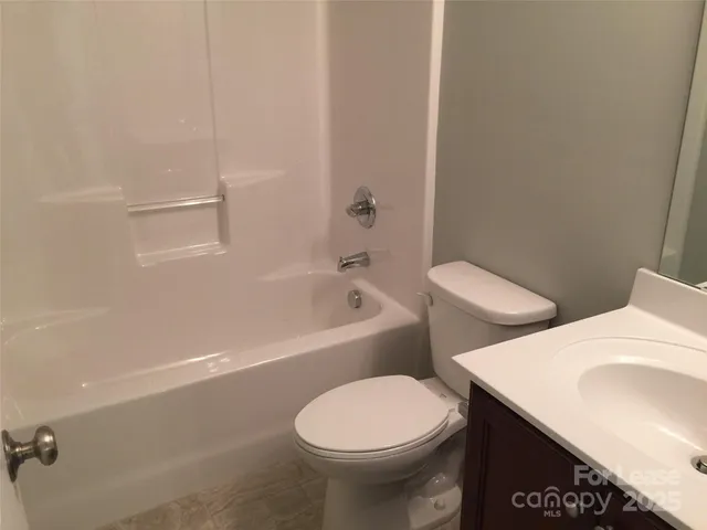 a white toilet sitting next to a bath tub