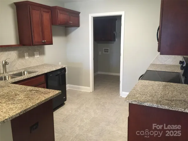 a kitchen that has a sink and a stove in it