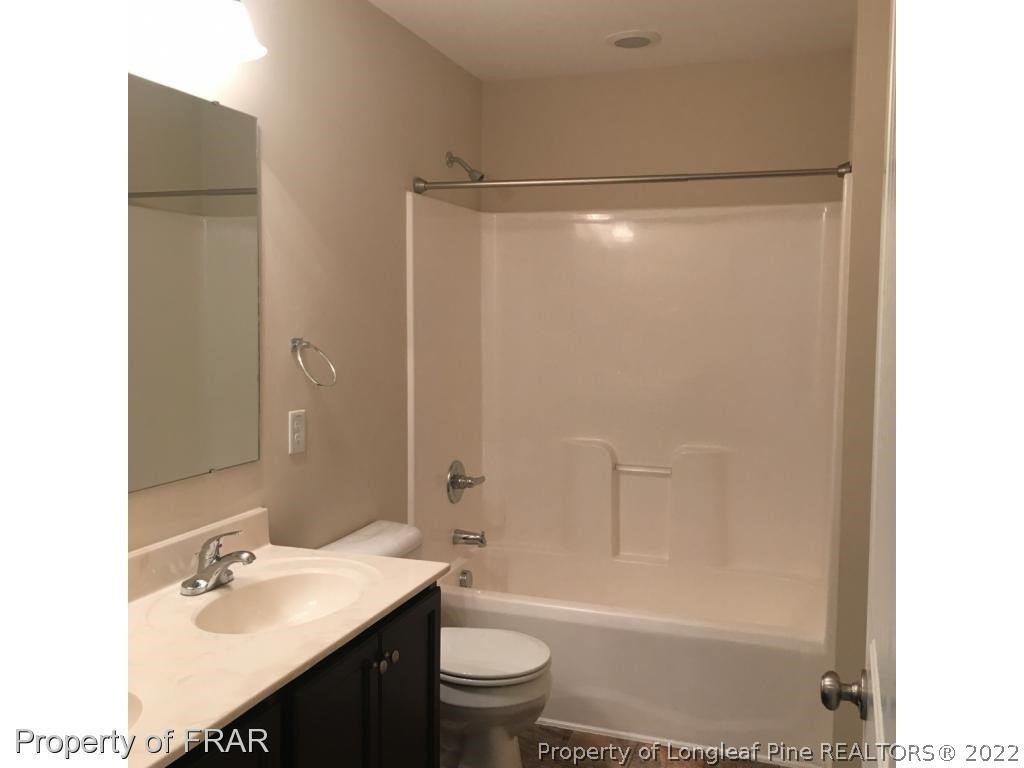 434 New Castle Lane Spring Lake, NC 28390 - Photo 12 of 12 a bathroom with a sink a toilet and shower
