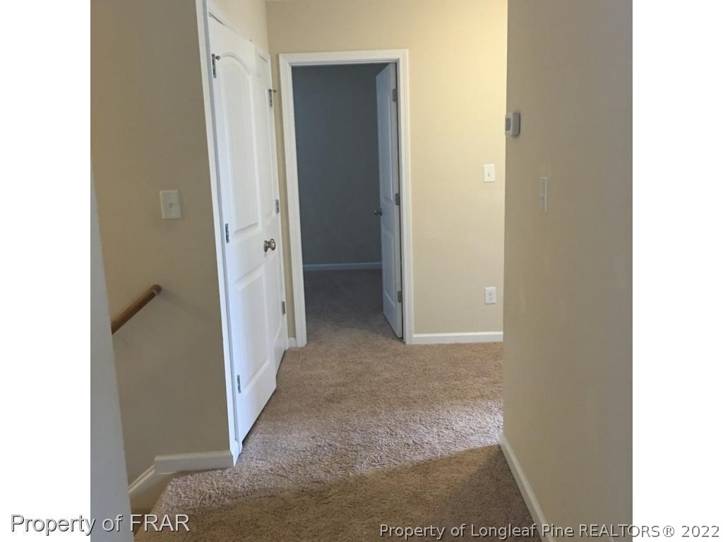 434 New Castle Lane Spring Lake, NC 28390 - Photo 5 of 12 a view of a hallway with wooden floor