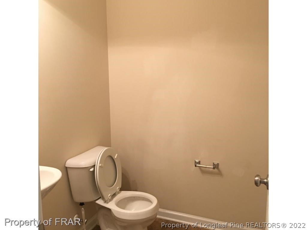 434 New Castle Lane Spring Lake, NC 28390 - Photo 9 of 12 a white toilet sitting next to a white wall