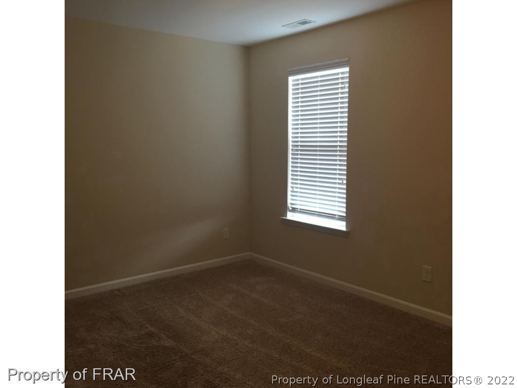 434 New Castle Lane Spring Lake, NC 28390 - Photo 10 of 12 a view of a room that has a window in it