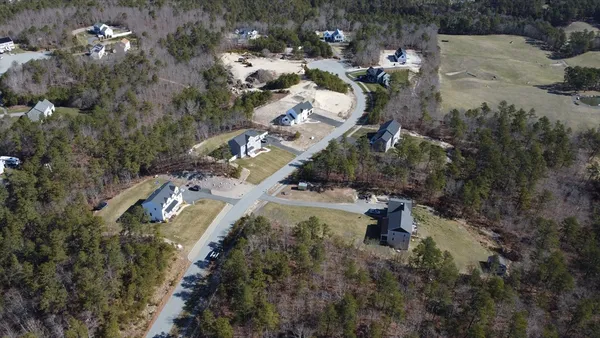 an aerial view of multiple house with yard