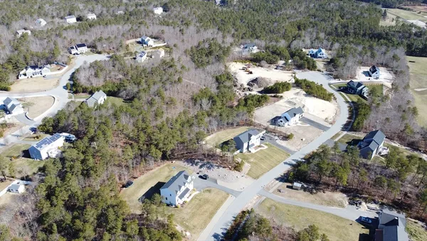an aerial view of a house with a yard basket ball court and outdoor seating