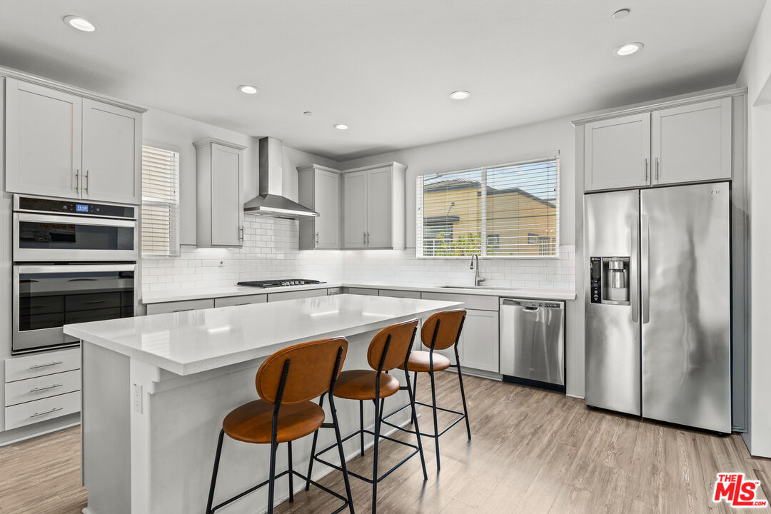 625 Daniel Freeman Circle Inglewood, CA 90301 - Photo 11 of 23 a kitchen with stainless steel appliances granite countertop a stove refrigerator sink and cabinets