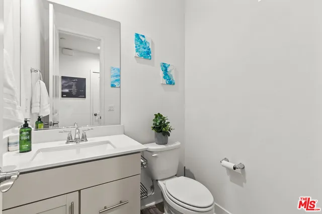 a bathroom with a sink mirror vanity and toilet