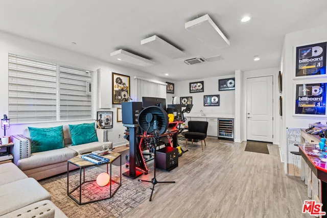 a living room with furniture a window and gym equipment