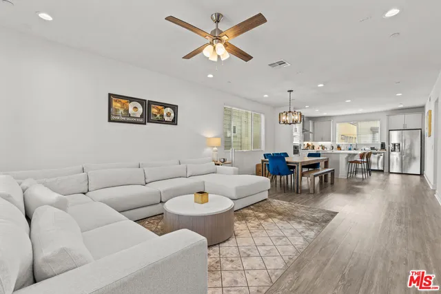 a living room with furniture and kitchen view