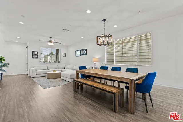 a living room with furniture a wooden floor and chandelier