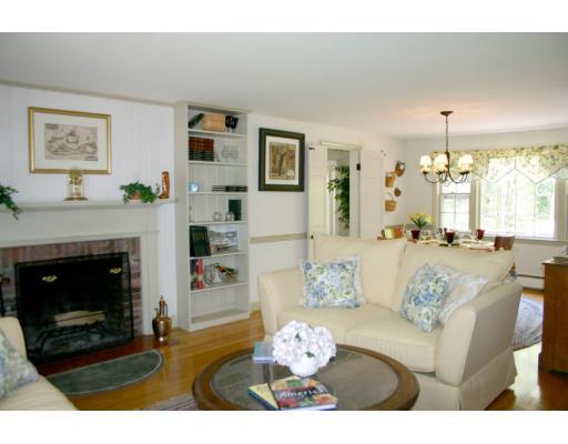18 White Road Wayland, MA 01778 - Photo 4 of 19 a living room with furniture a fireplace and a chandelier