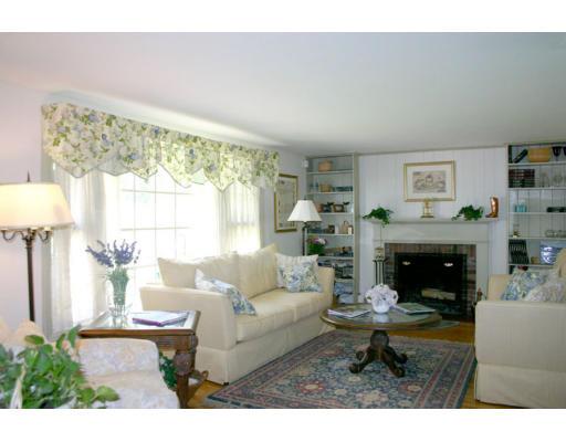 18 White Road Wayland, MA 01778 - Photo 9 of 19 a living room with furniture a fireplace and a table