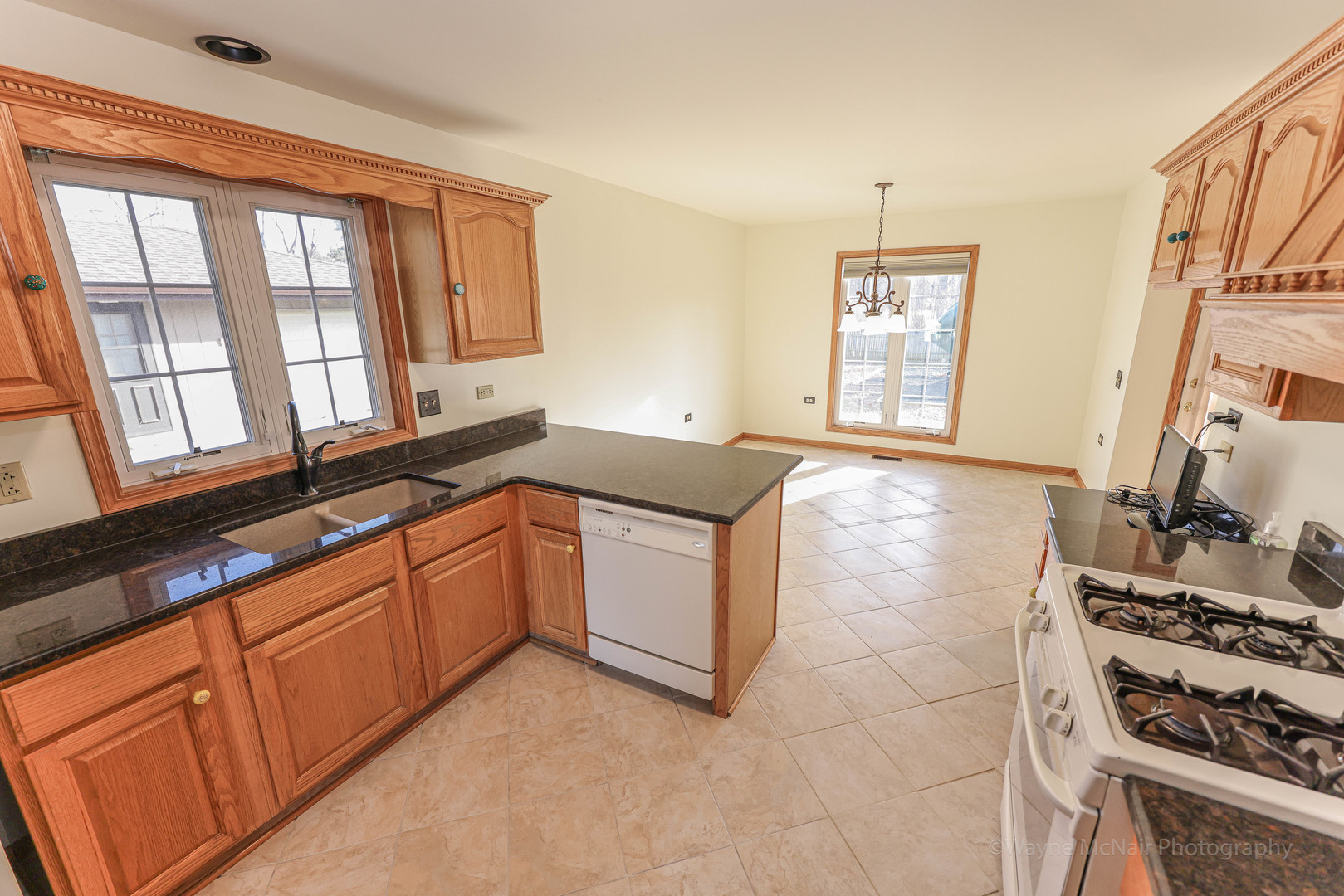 206 1/2 Redbud Drive Joliet, IL 60433 - Photo 12 of 34 a kitchen with stainless steel appliances granite countertop a stove a sink and a microwave