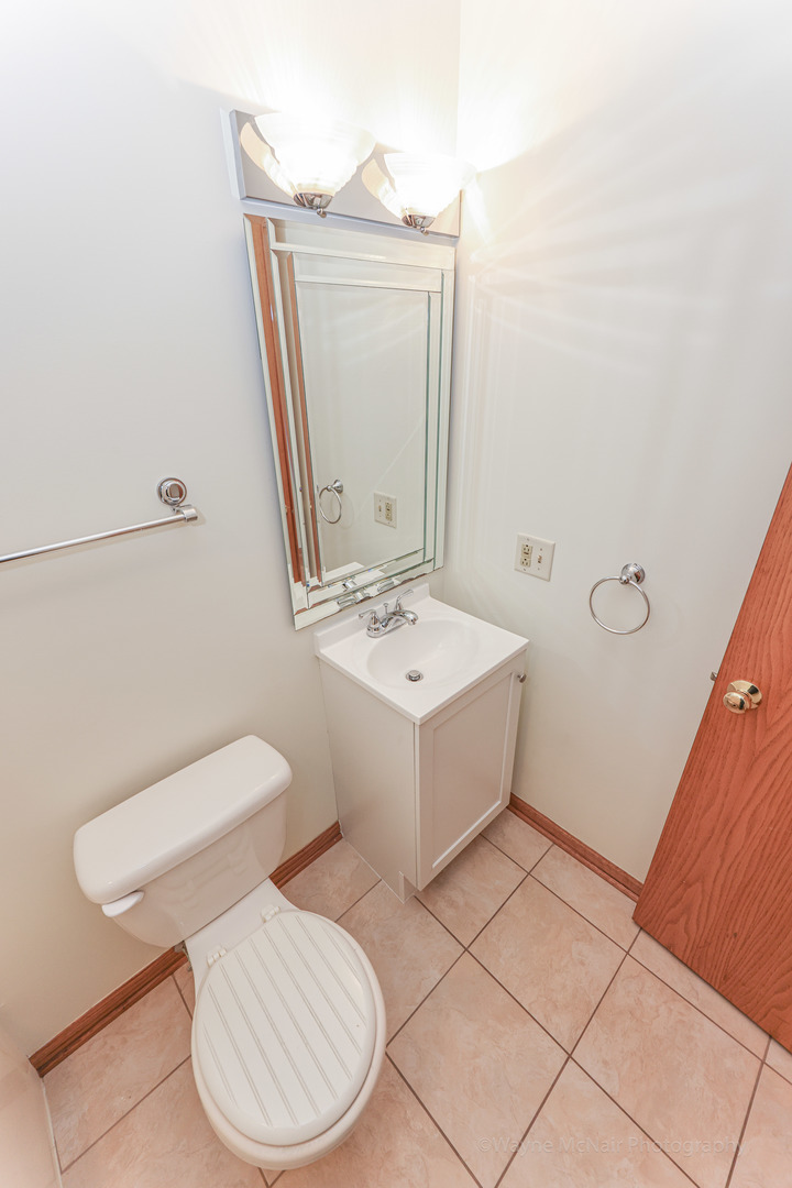 206 1/2 Redbud Drive Joliet, IL 60433 - Photo 21 of 34 a bathroom with a sink mirror vanity and toilet