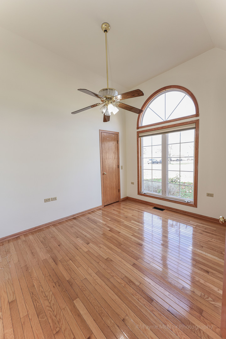 206 1/2 Redbud Drive Joliet, IL 60433 - Photo 6 of 34 a view of empty room with wooden floor and fan
